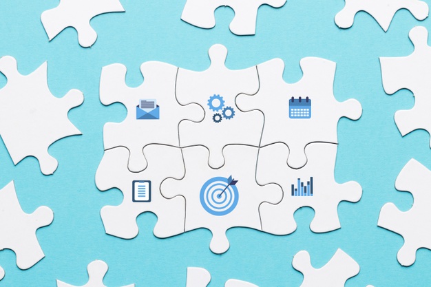 Marketing icon on white puzzle piece on blue background Free Photo